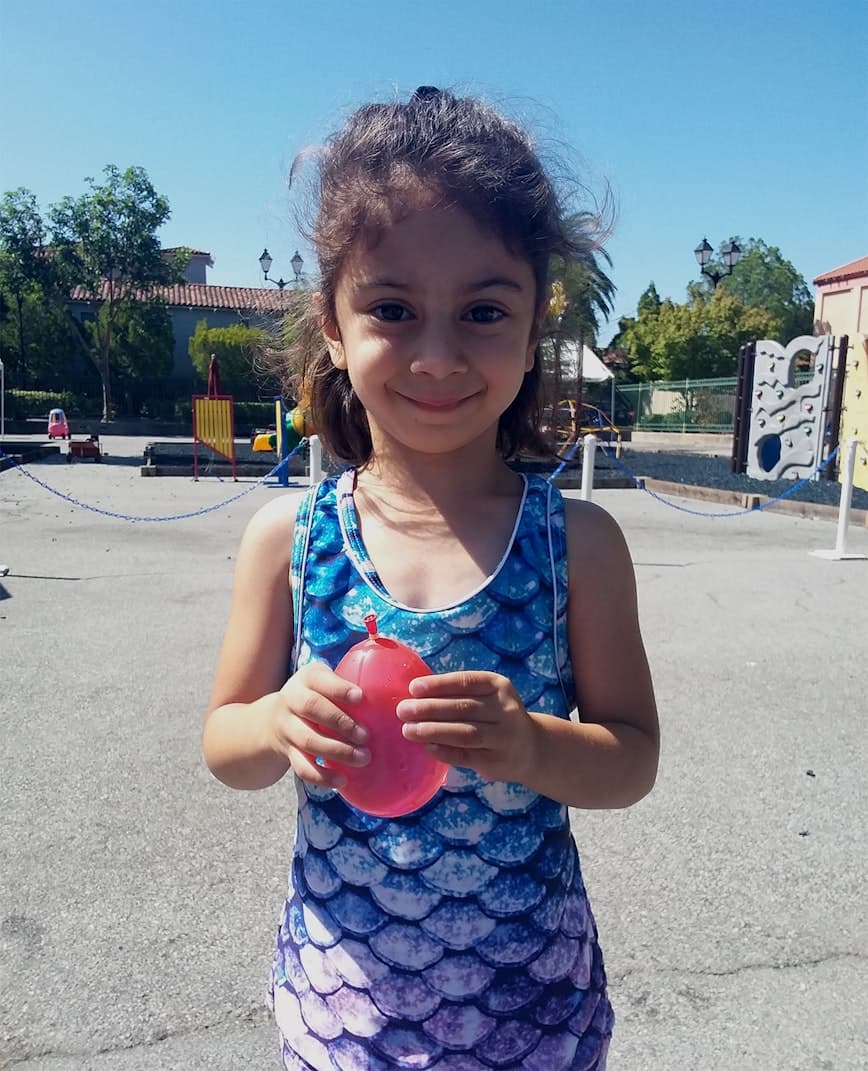 Child with water balloon