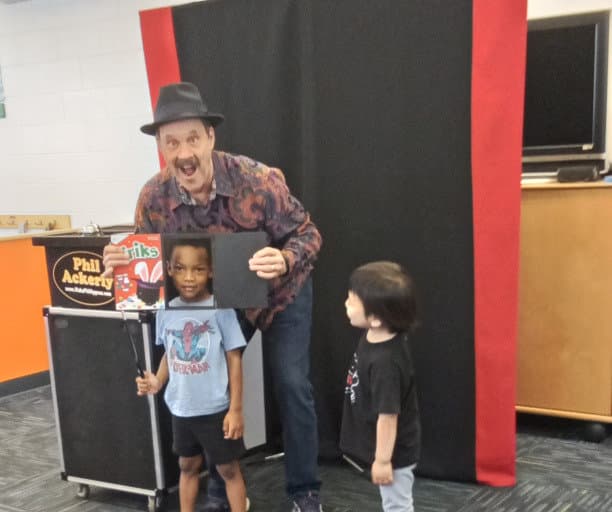 Magician with two students helping the trick