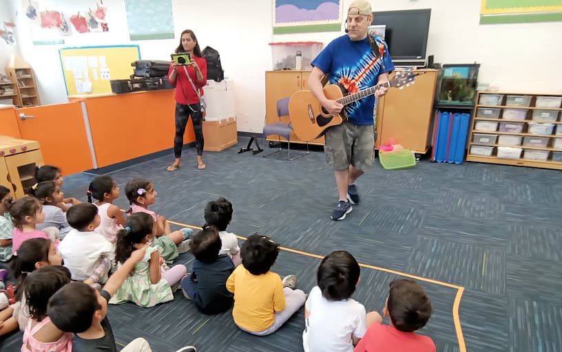 Guitarist playing for the children